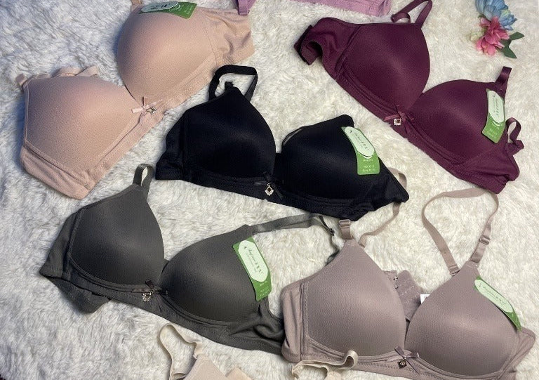 Collection of bras in various colors on a white surface.